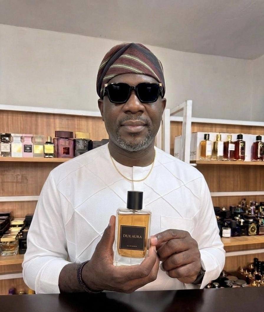 Man holding Dux Aura bottle
